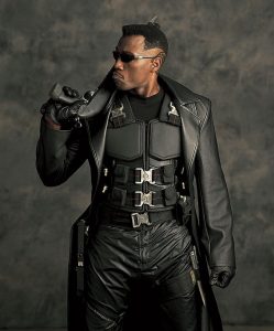 Actor Wesley Snipes in character as Blade, Dressed in full leather combat costuming, dark sunglasses, and a weapon slung over his shoulder.