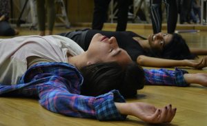 Image from Samita Sinha’s “Voice as Matter” workshop at Centro Nacional de las Artes in Mexico City. She and a student are lying on the ground in a moment of vocal work.