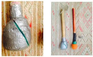 Two Mallets. 1. Close up of a wooden mallet, wrapped in duct tape which is splitting along a diagonal. 2. Two mallets placed side by side, one wrapped in duct tape with a rope handle, and one brown with a black neck and an orange head.